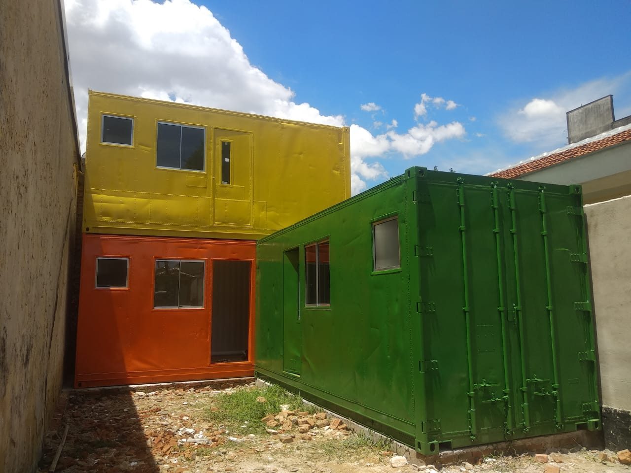 Painted shipping containers waiting in the empty lot in Lapa